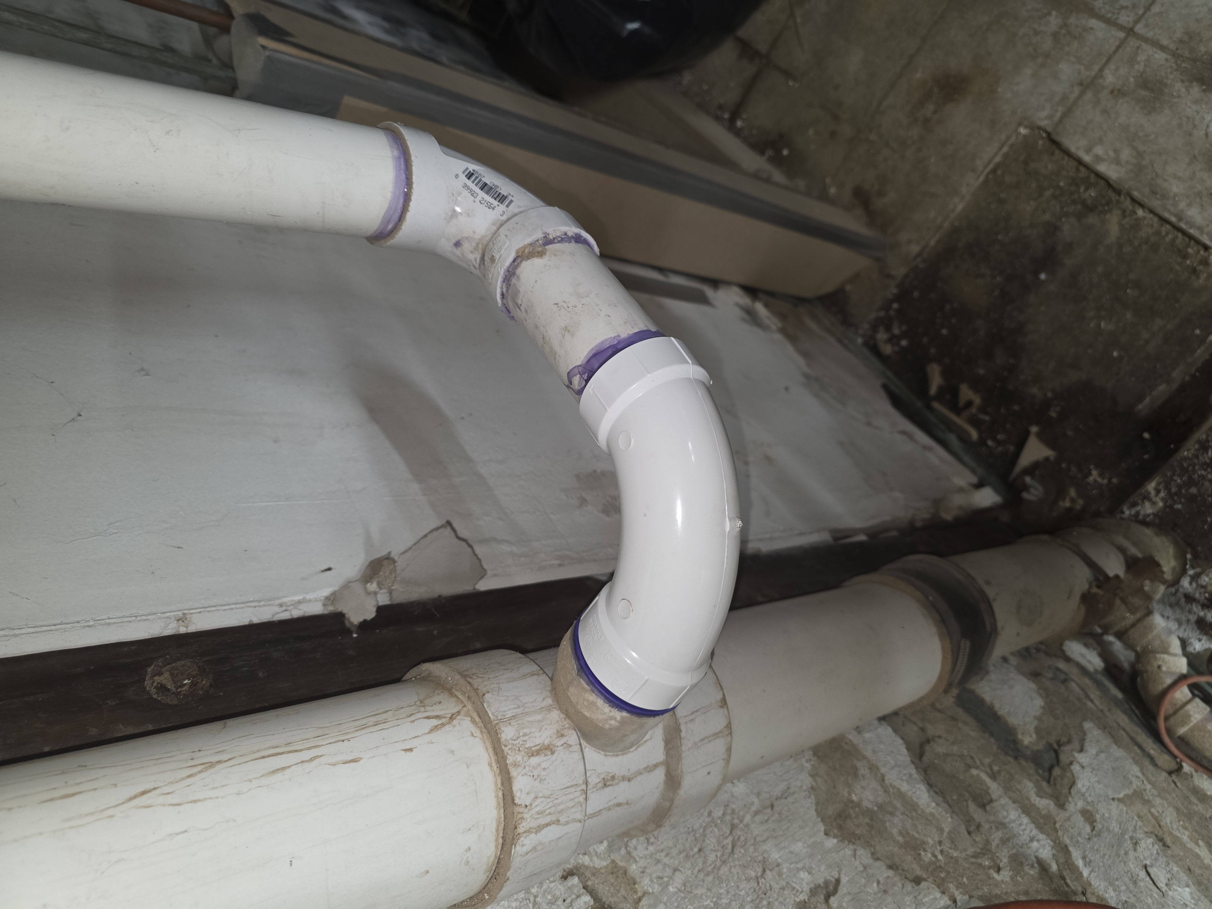 New PVC fittings tied into an older drain stack