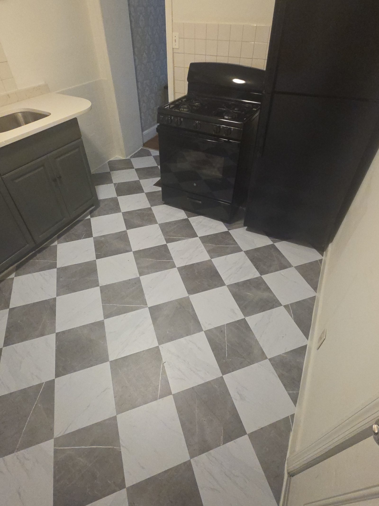 Finished kitchen remodel with checkerboard tile flooring